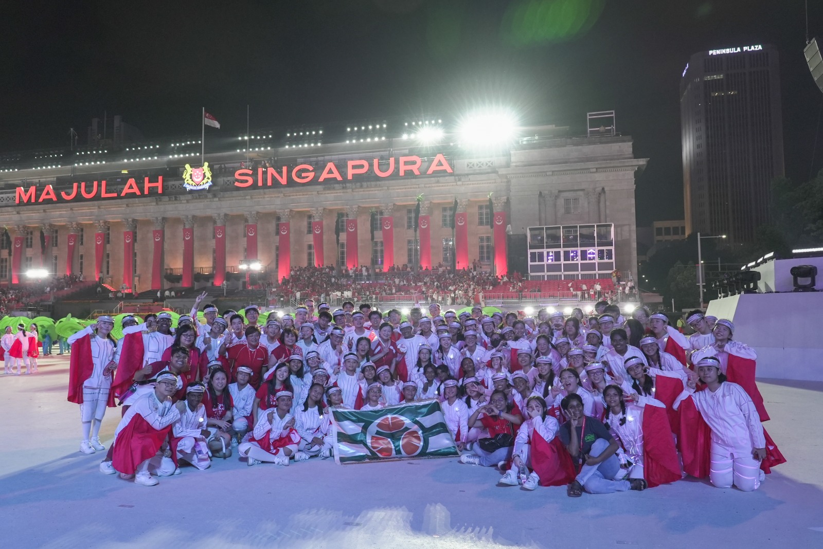 Group photo of students and teachers on the stage after the NDP 2023